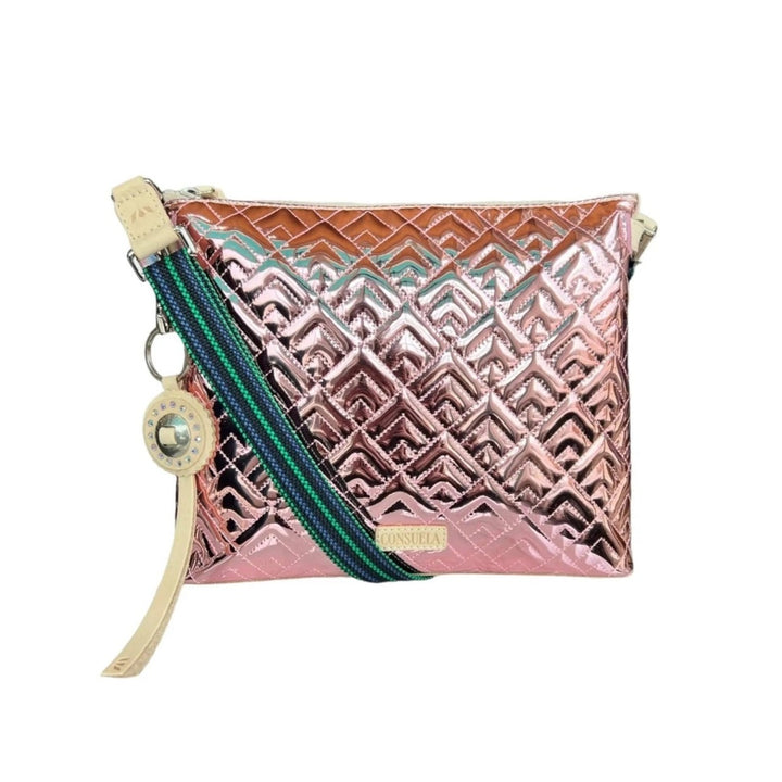 Quinn Downtown Crossbody | Consuela | A shimmering pink crossbody bag with a geometric pattern, blue/green crossbody strap, and Diego leather accents.