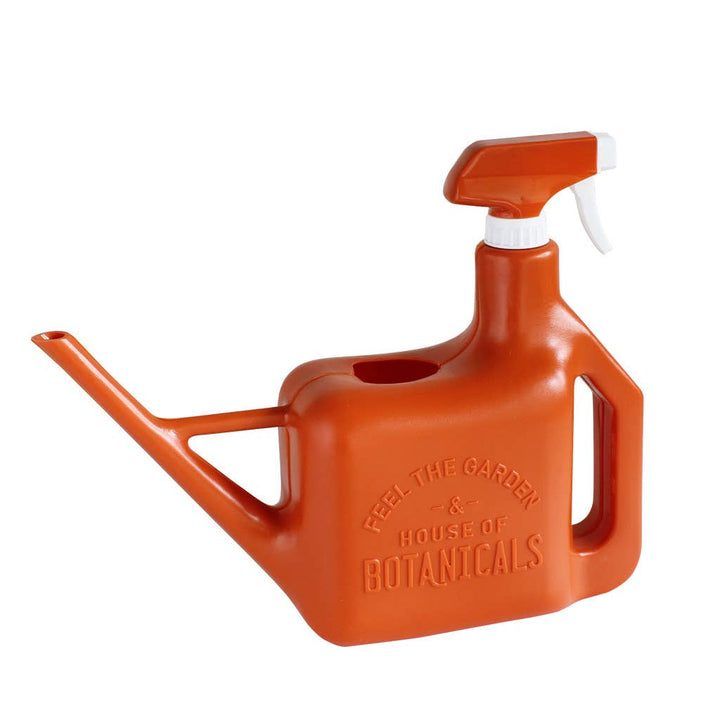 A red watering can that also has a spray bottle function