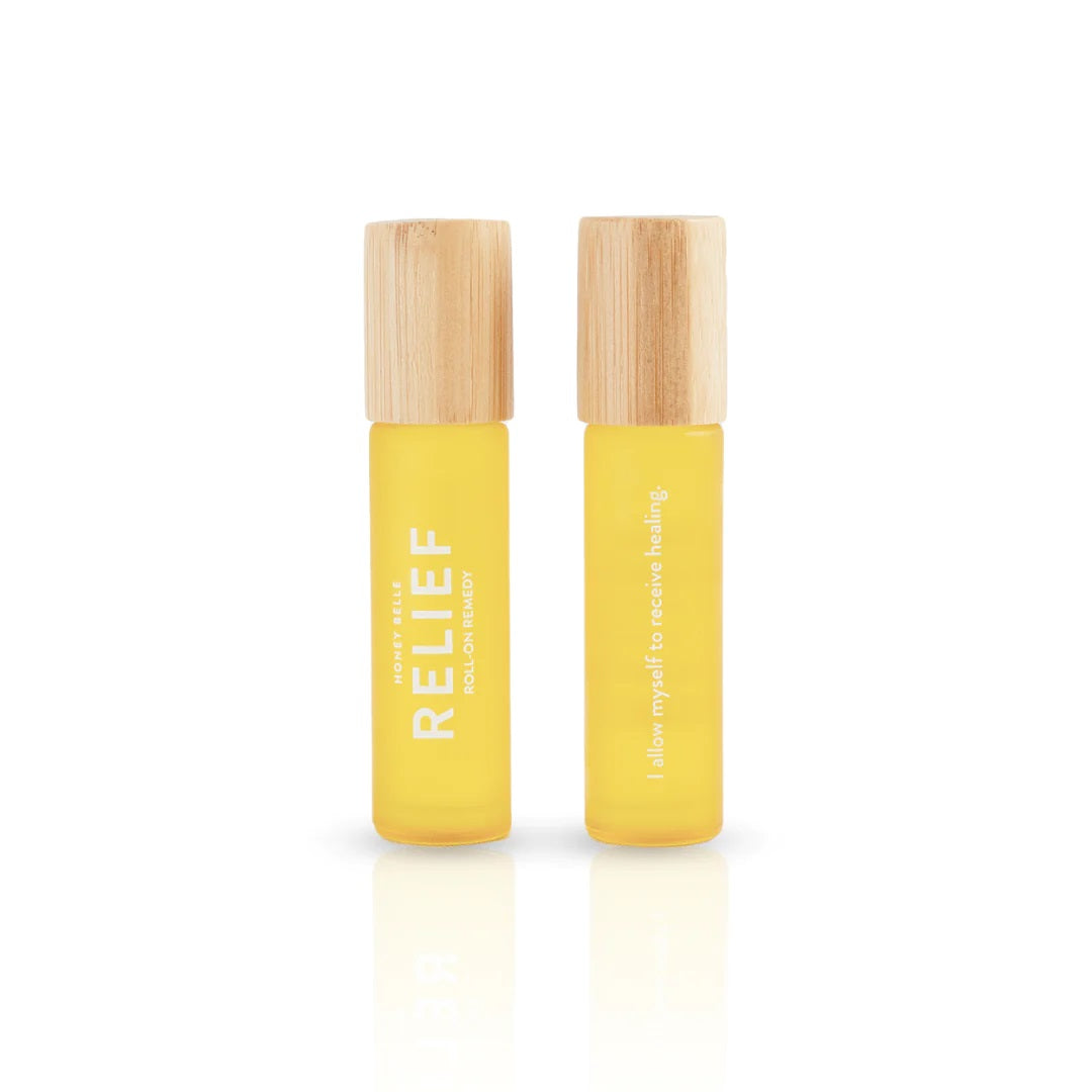 Relief Roll-On Remedy | Honey Belle | A yellow frosted glass roll on container. Wooden textured lid.