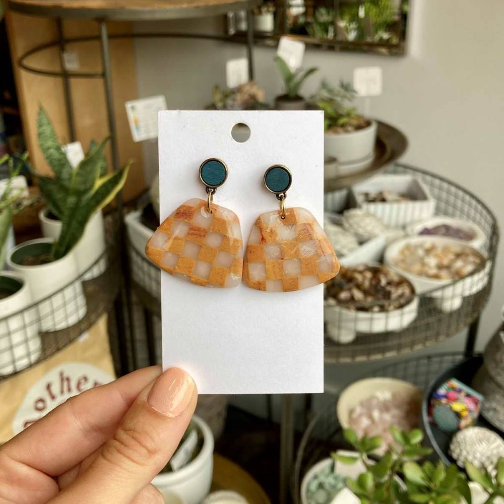 Rivergirl Curiosities | Checkered Polymer Clay Earrings |  Orange and clear checkered earrings with a teal accent stud.