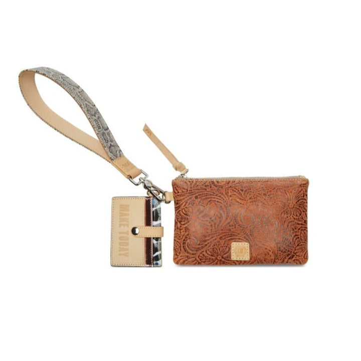 Sally Combi | Consuela | A brown leather bag with an organic floral patterned surface. The wrist strap is a neutral snake skin pattern with accent diego leather. The card holder is diego leather with patterned accents and reads "Make Today".