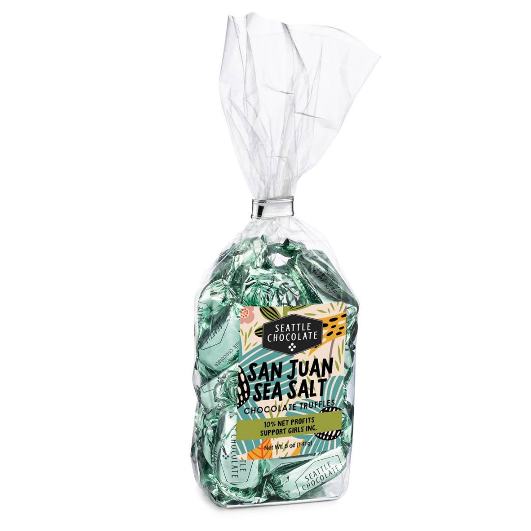 San Juan Sea Salt Truffle Bag | A clear bag with mint green individually wrapped chocolates. The label is floral and fun with text that reads "Seattle Chocolate, san juan sea salt chocolate truffles, 10% net profits support girls inc. Net Wt. 5ox (141g)