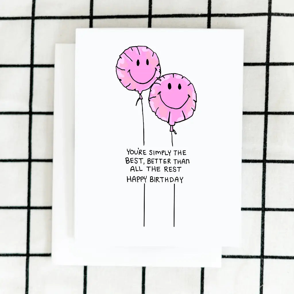 A white card with two pink balloons with smiley faces. Text reads "You're simply the best, better than all the rest. Happy Birthday.