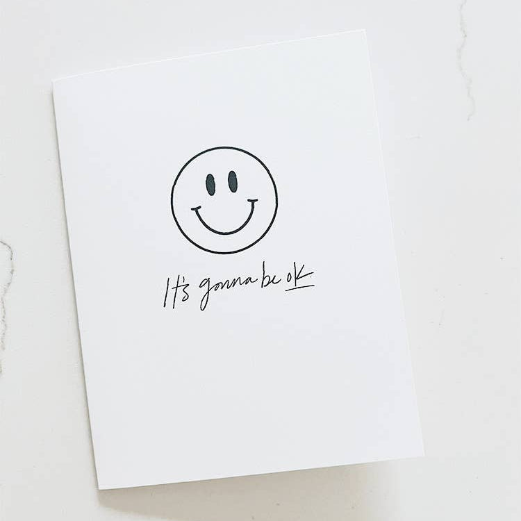 Motivational card with smiley face and 'It's gonna be ok' text on a white background