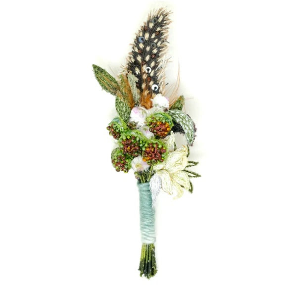 Trovelore | Spotted Feather Boutonniere | A boutonniere made of beads, sequins, and embroidery.