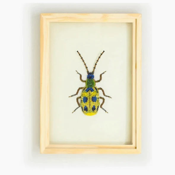 Trovelore | Cucumber Beaded Art | A yellow, blue, and green spotted beetle created with beads, sequins, and embroidery.