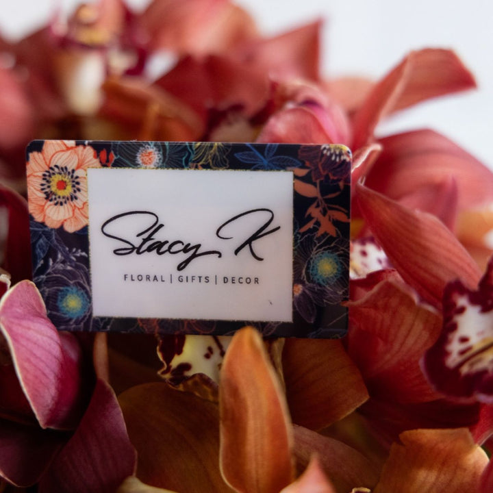 Floral business card with 'Stacy K' branding on a background of pink and red flowers.