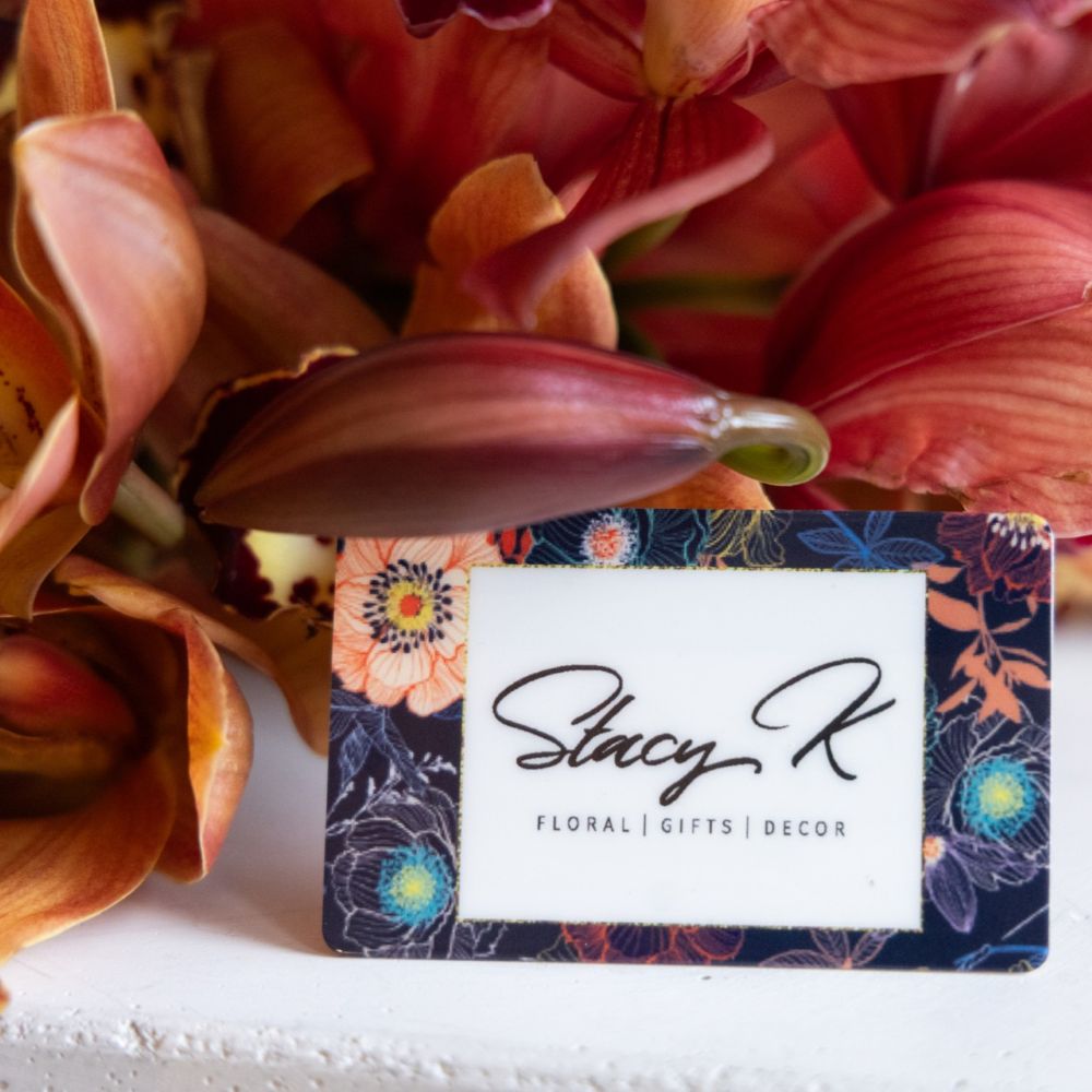 Floral arrangement with a Stacy K business card in front