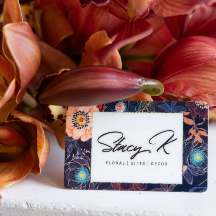 Floral arrangement with a Stacy K business card in front