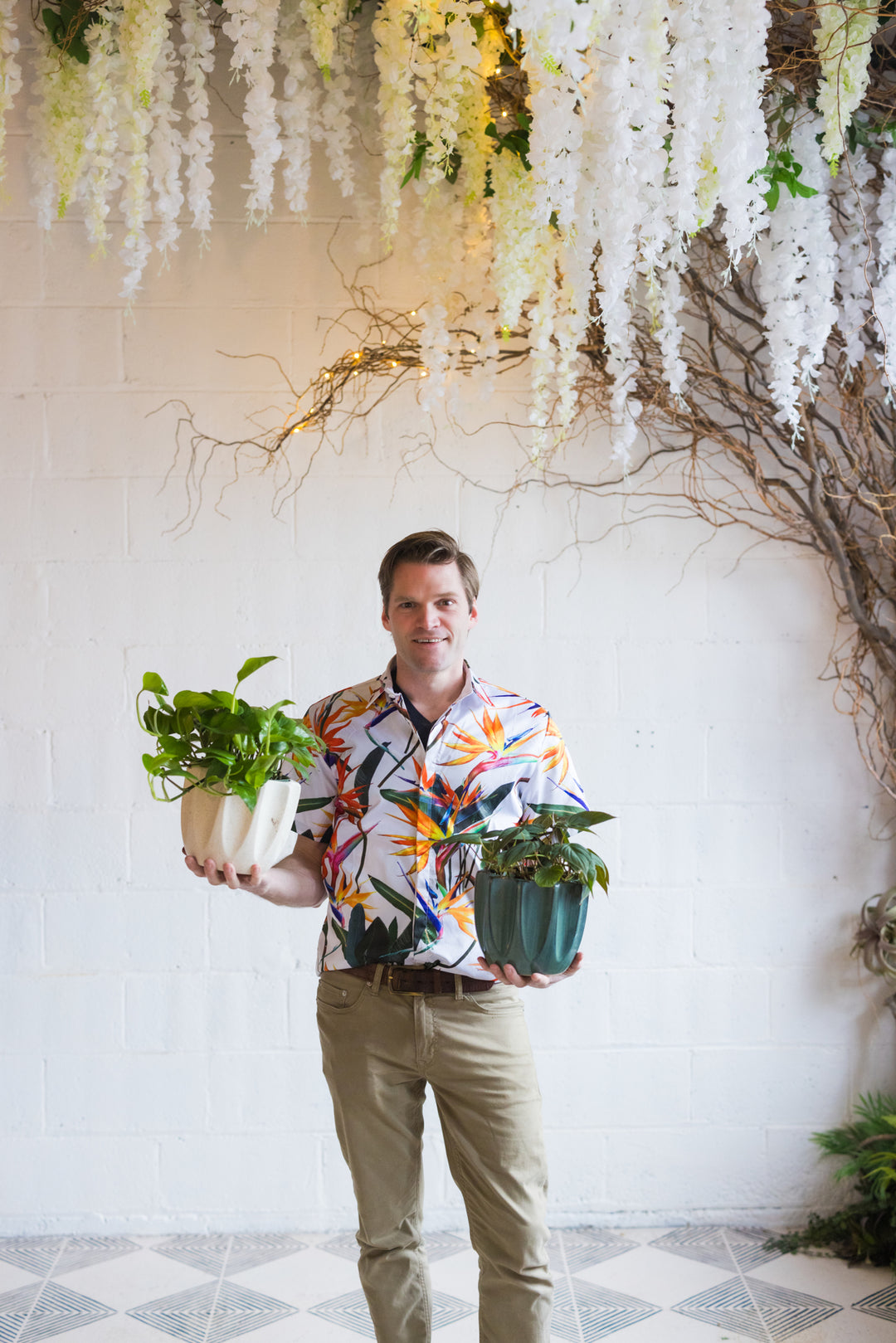 Photo of Michael Studio Director holding two plants
