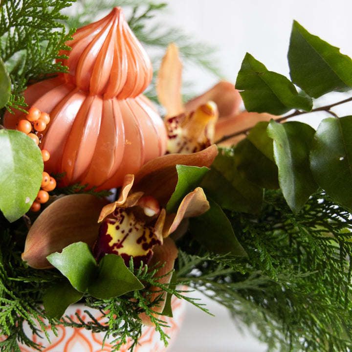 Decorative arrangement with pink pumpkins and flowers on a white background