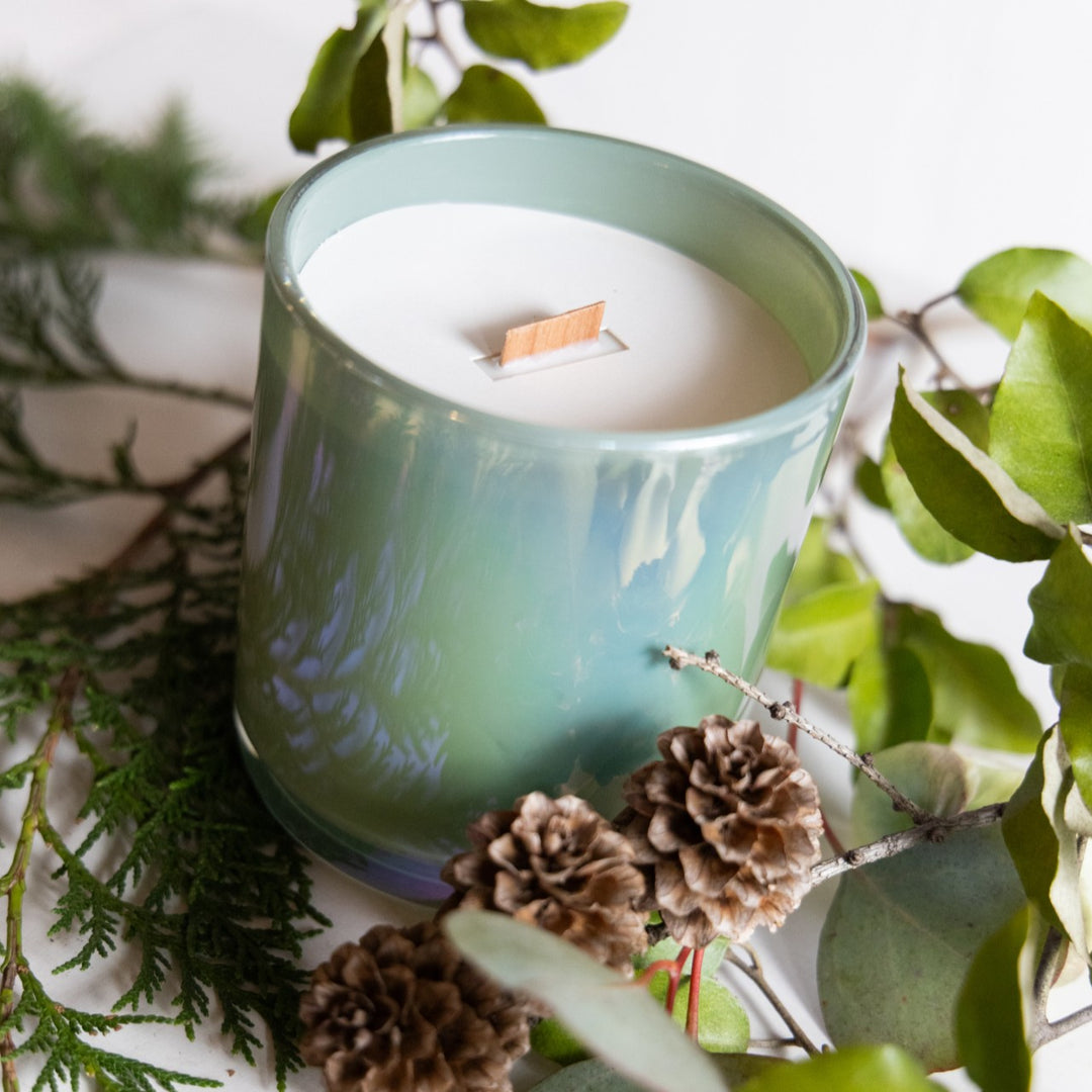 Stacy K Floral | Green candle with decorative elements on a white background