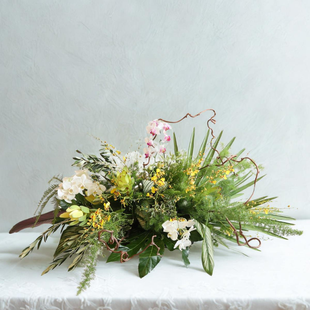 Stacy K Floral | Natural Spray | Sympathy floral arrangement with lots of greens and orchids.