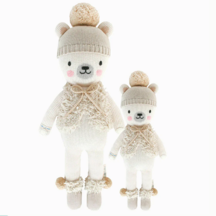 Stella the Polar Bear | Cuddle + Kind | A white polar bear with a hat, vest, and boots. 20" size and 13".