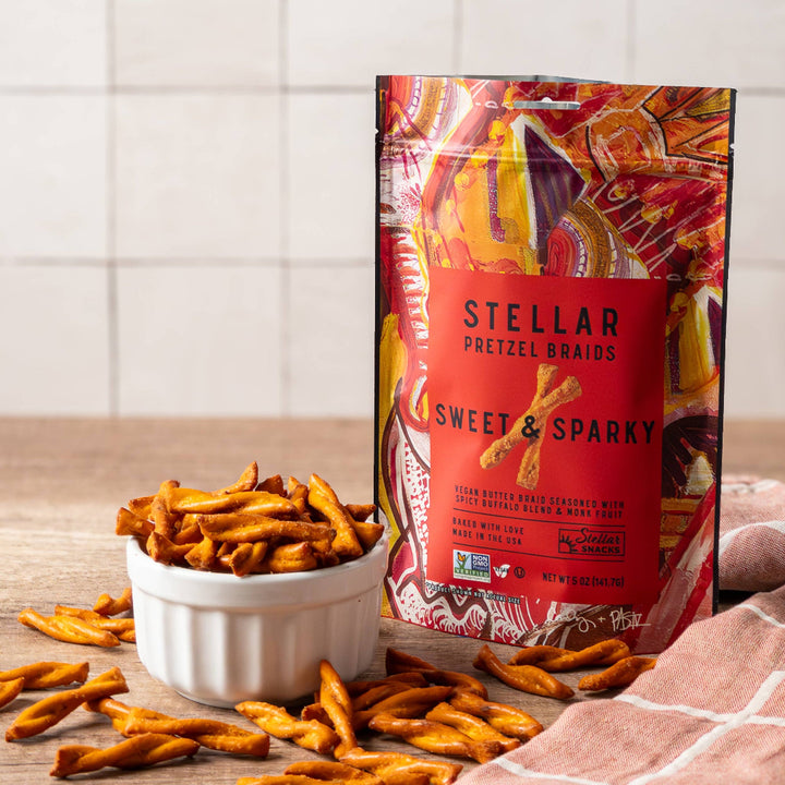 Stellar Sweet &amp; Sparkly pretzel snacks with packaging on a wooden surface.