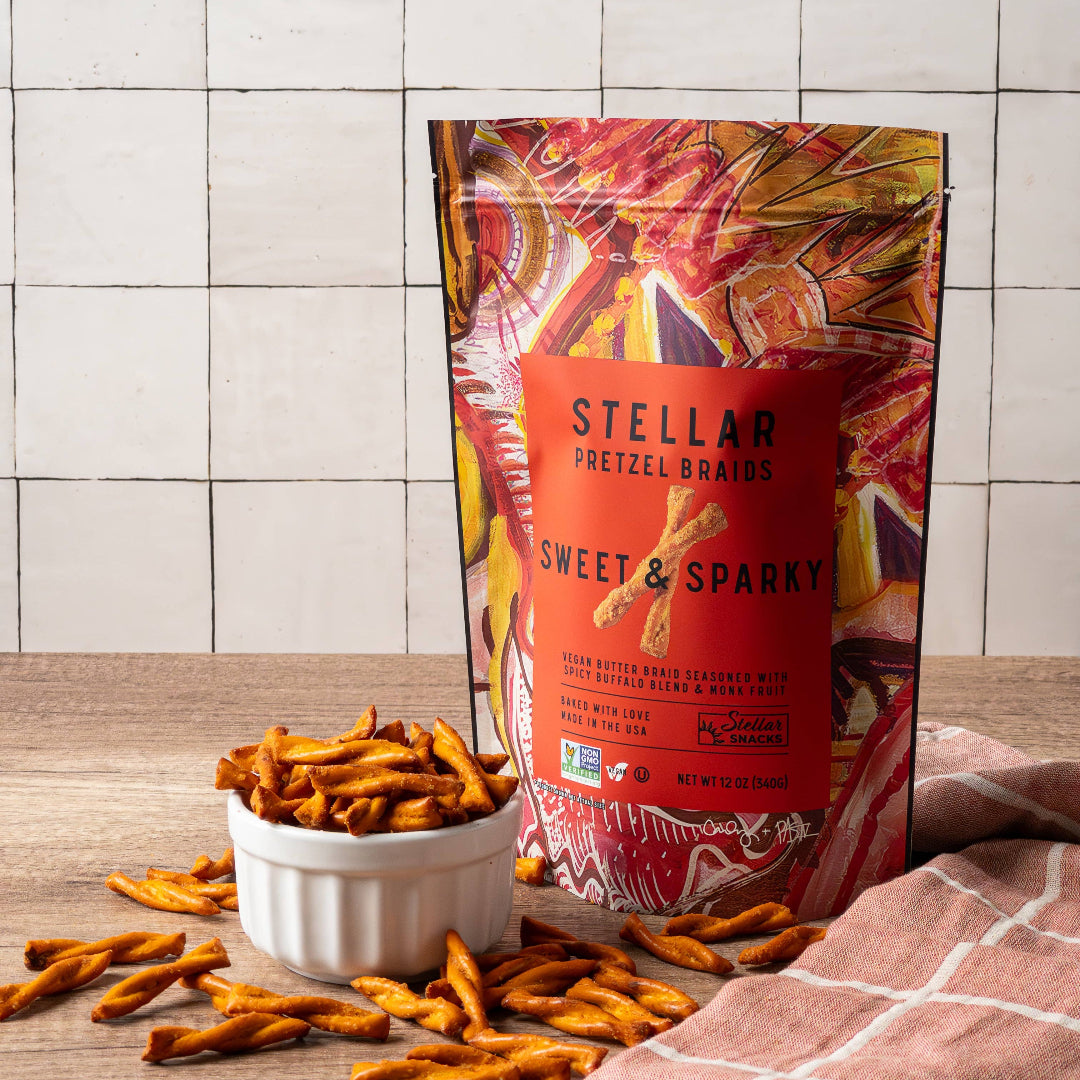Stellar pretzel snacks with a colorful packaging on a wooden surface and tiled wall background