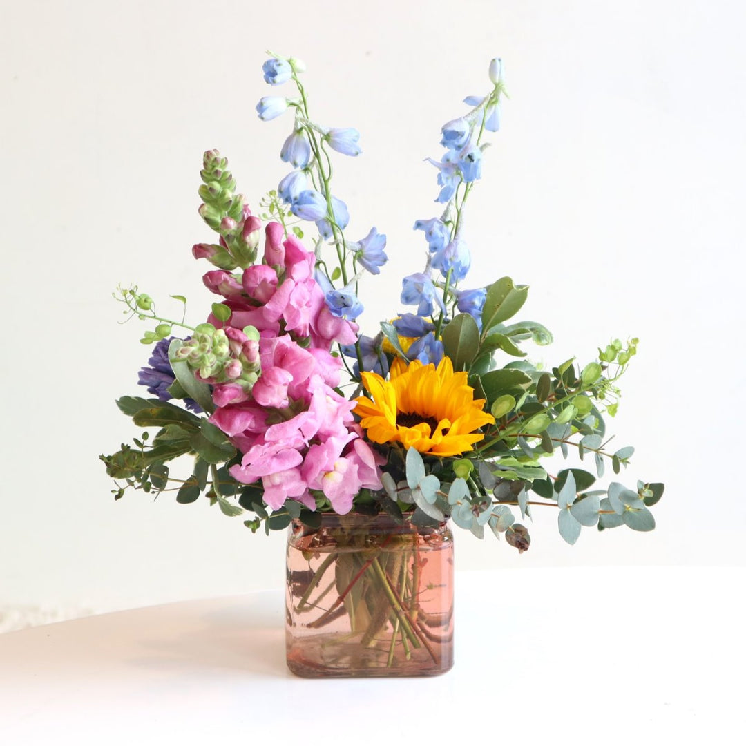 Snapdragons, delphinium, eucalyptus, and sunflowers.