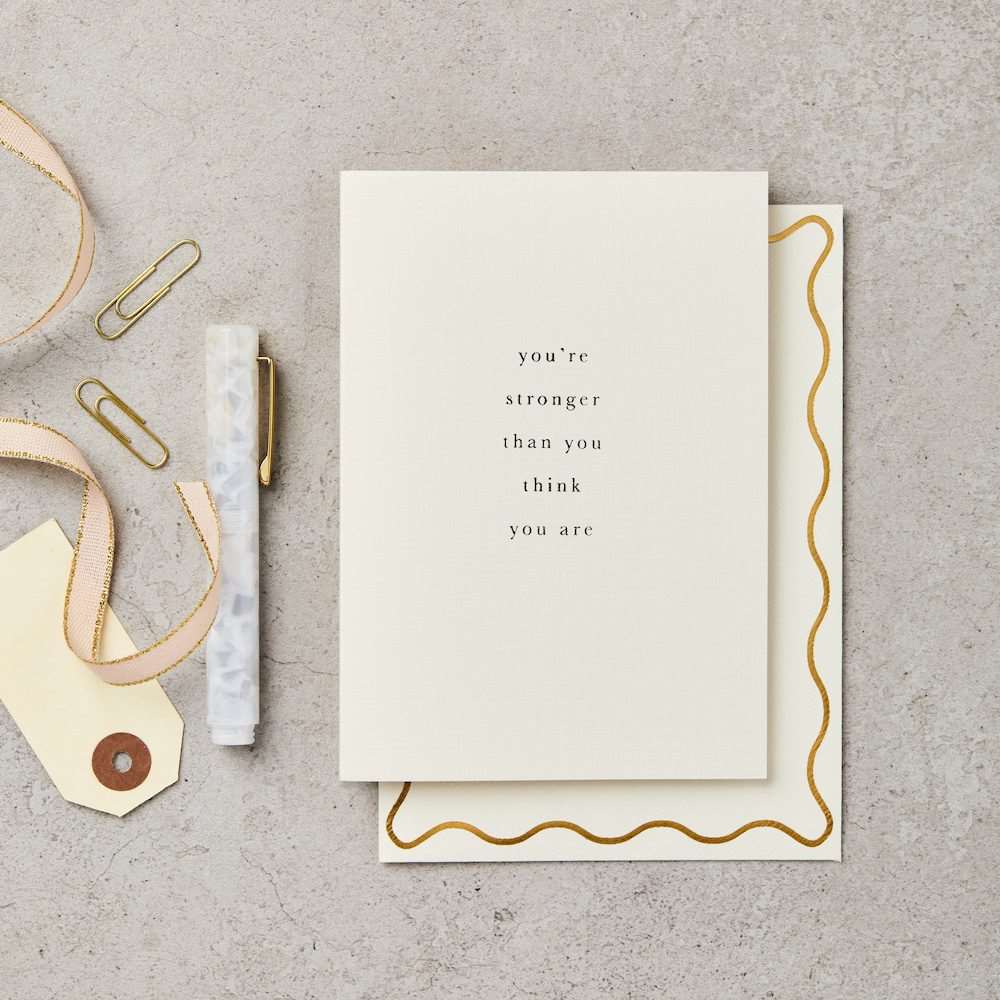 A white card with simple type face text "you're stronger than you think you are"