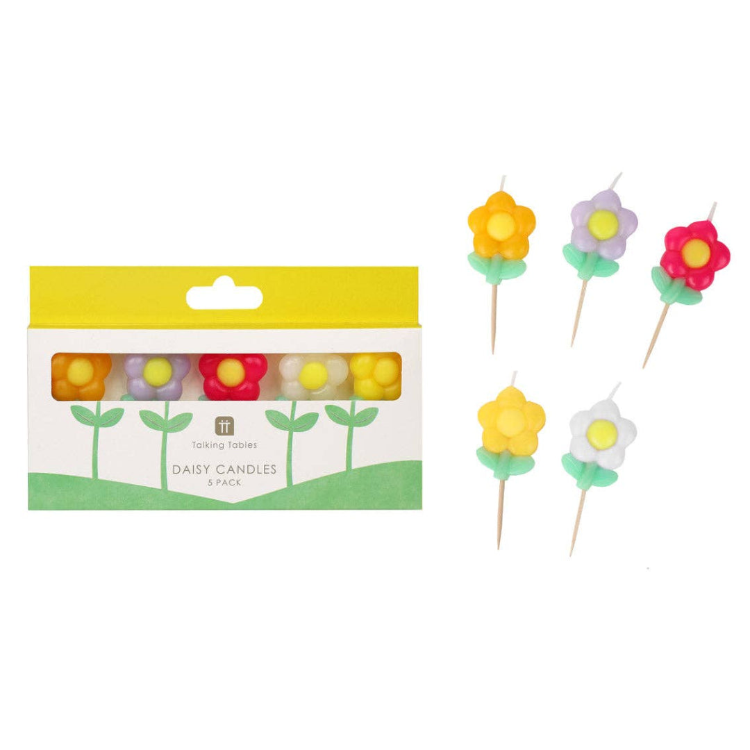 Flower-shaped candles with packaging on a white background