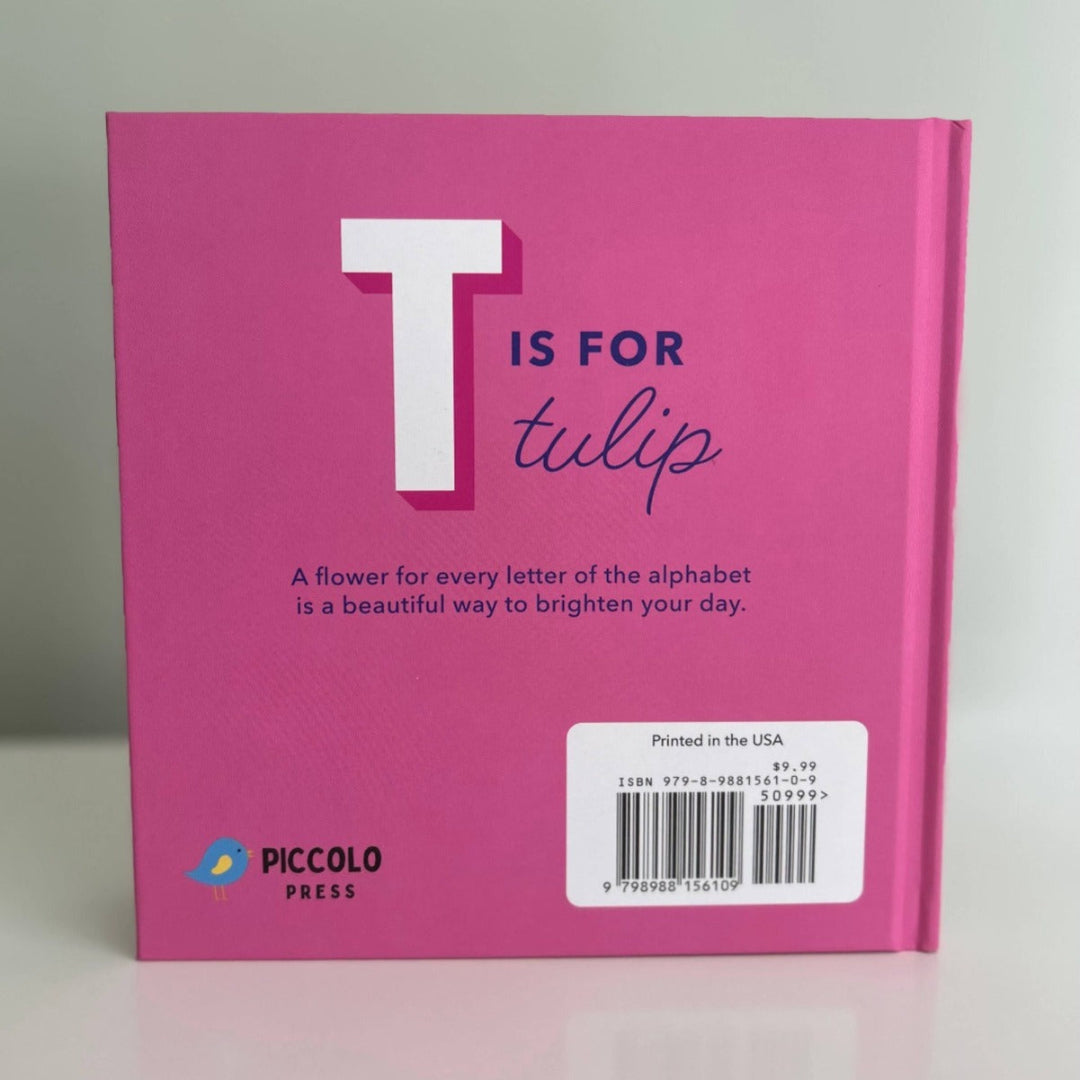 The Alphabet in Bloom is a 7x7 hardcover flower alphabet book with boldly illustrated design. Reverse side says "T is for tulip" A flower for every letter of the alphabet is a beautiful way to brighton your day.