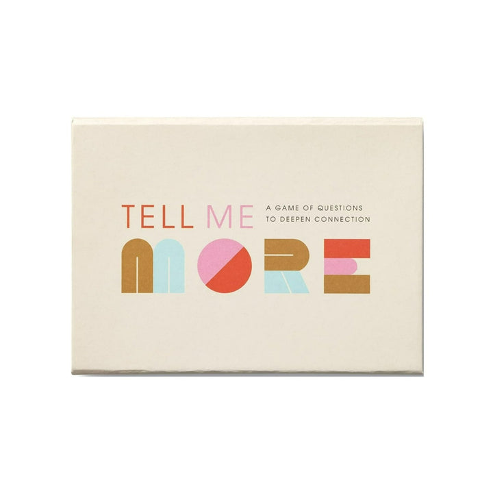 Tell Me More: A game of questions to deepen connection | A cream colored box with red, pink, gold, and light blue title.
