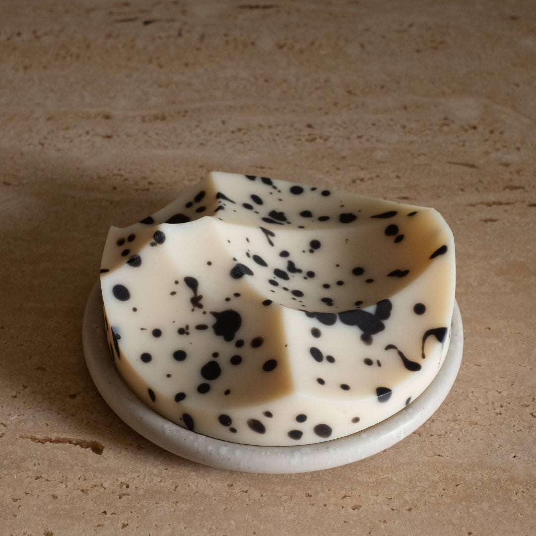 Decorative soap with black speckles on a beige background