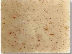 Beige soap with brown speckles on a white background