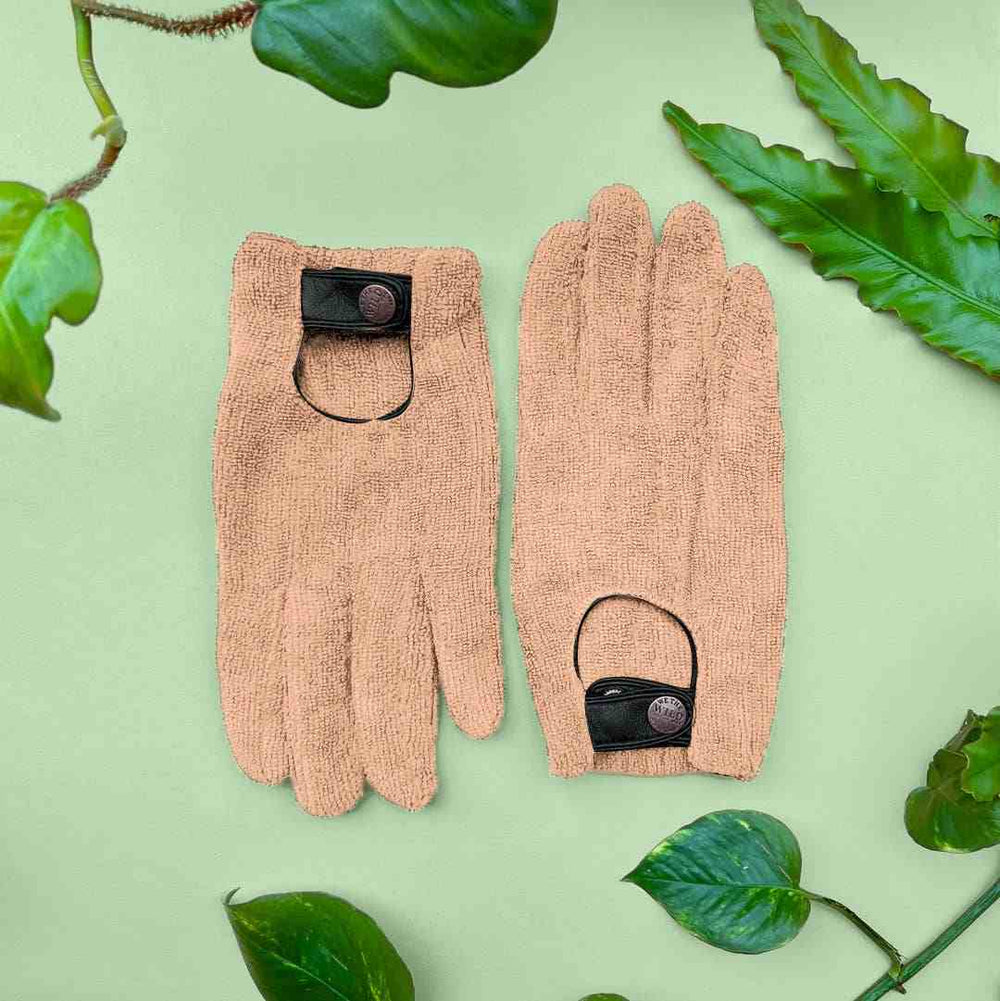We The Wild | Plant leaf dusting gloves | Pair of beige dusting gloves with black accents on a green background with leaves.