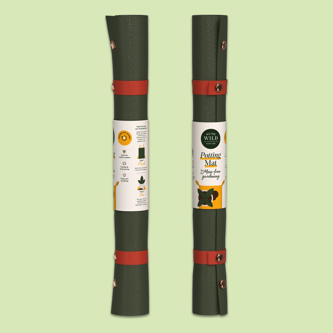 We The Wild | Two rolled-up potting mats with labels on a light green background
