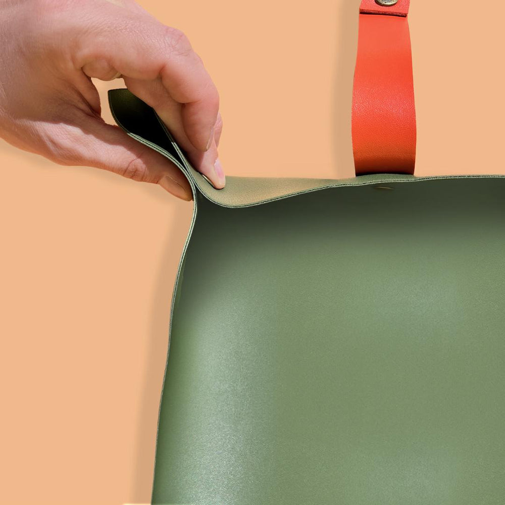 We The Wild | Repotting mat, green with an orange handle.