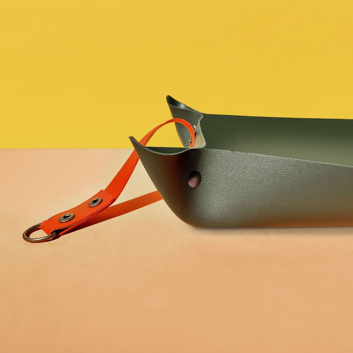 We The Wild | Repotting mat, green with an orange handle.