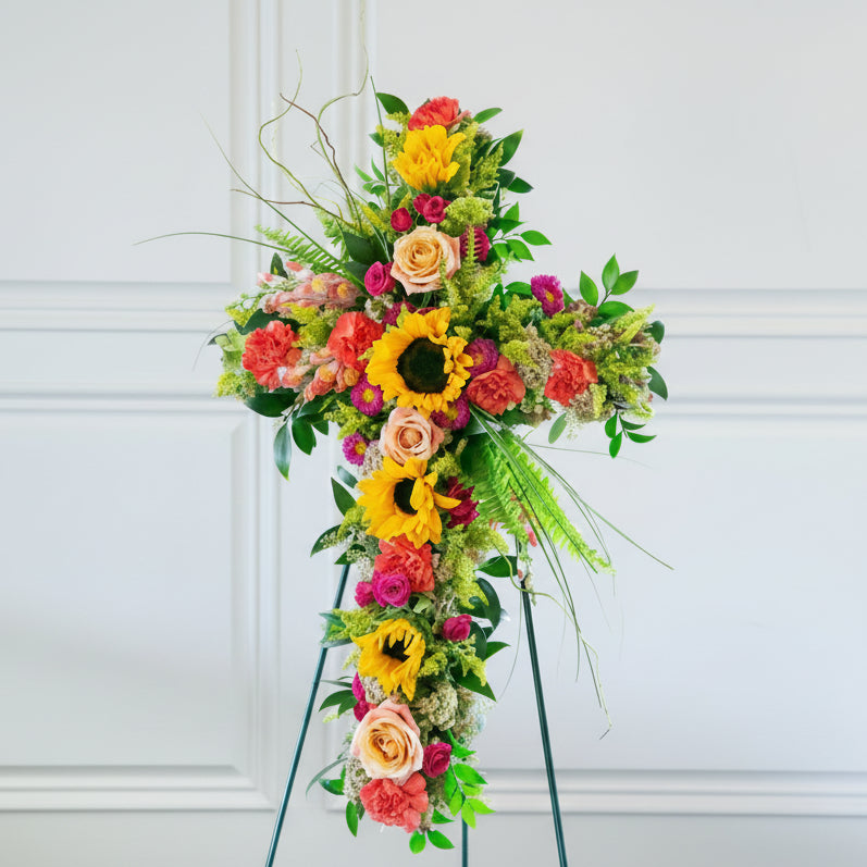 Colorful floral arrangement on a stand against a white background