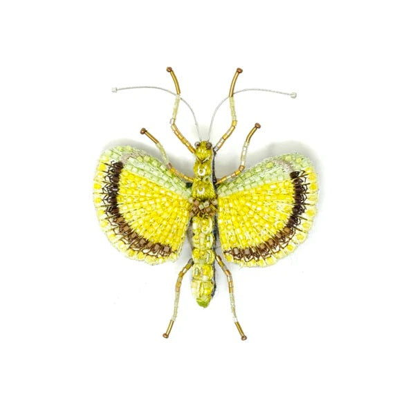 Decorative butterfly with yellow and brown pattern on a white background