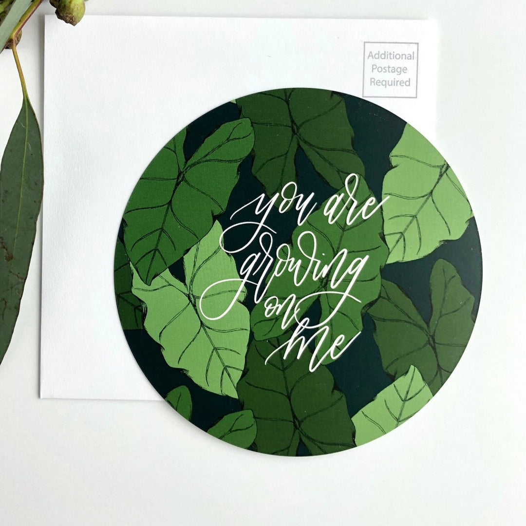 You Are Growing On Me | The House Of Roushey | Greeting Card | A round card with green plants and cursive white text that reads "you are growing on me".
