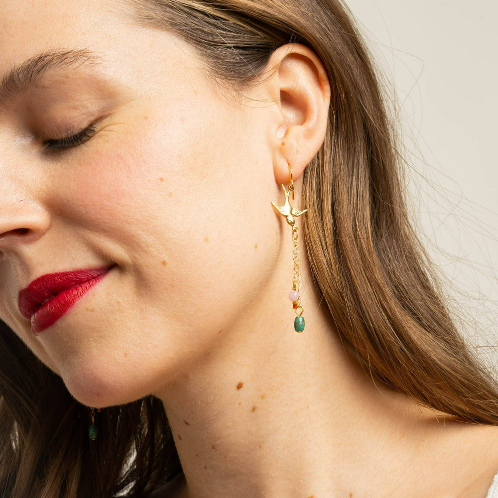 Nest Pretty Things | Long Bird Charm Earrings | Close up of the earrings on a model for scale reference.