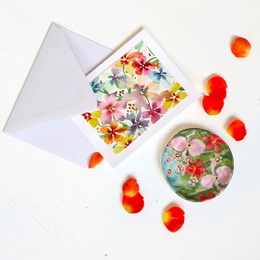 Andrea Durfee | Greeting Cards | A hand painted greeting card with a colorful floral design. Photo is decorated with loose flower petals and a handpainted ceramic dish.