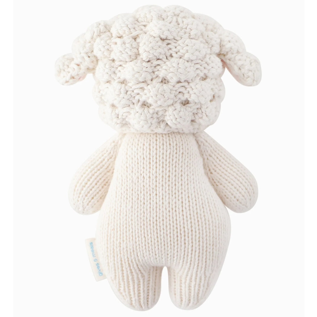 Baby Lamb | Cuddle + Kind | A reverse shot of the hand knit lamb plush toy showing the textured bonnet.