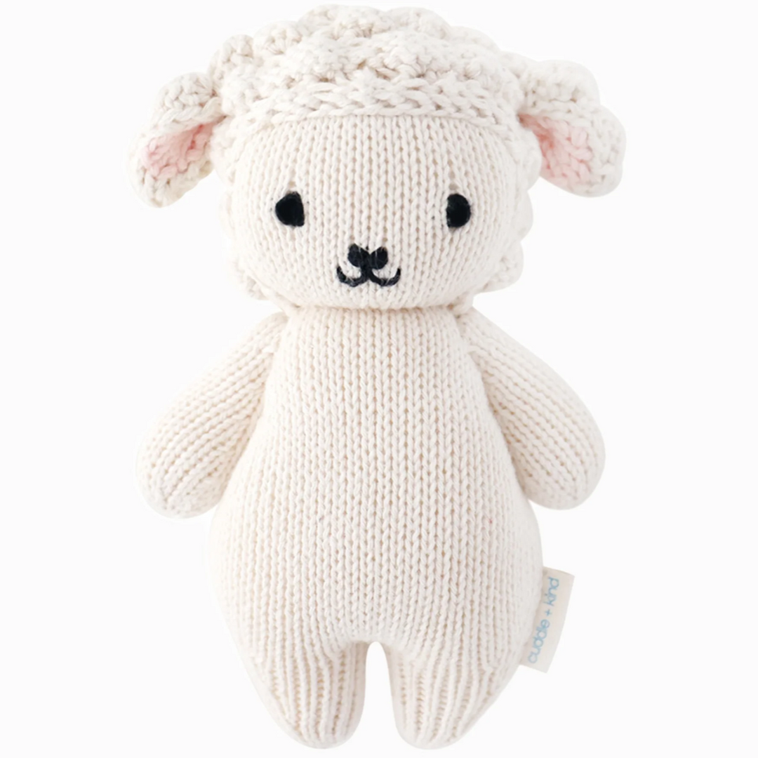 Baby Lamb | Cuddle + Kind | A white knit lamb plush with textured bonnet and ears.
