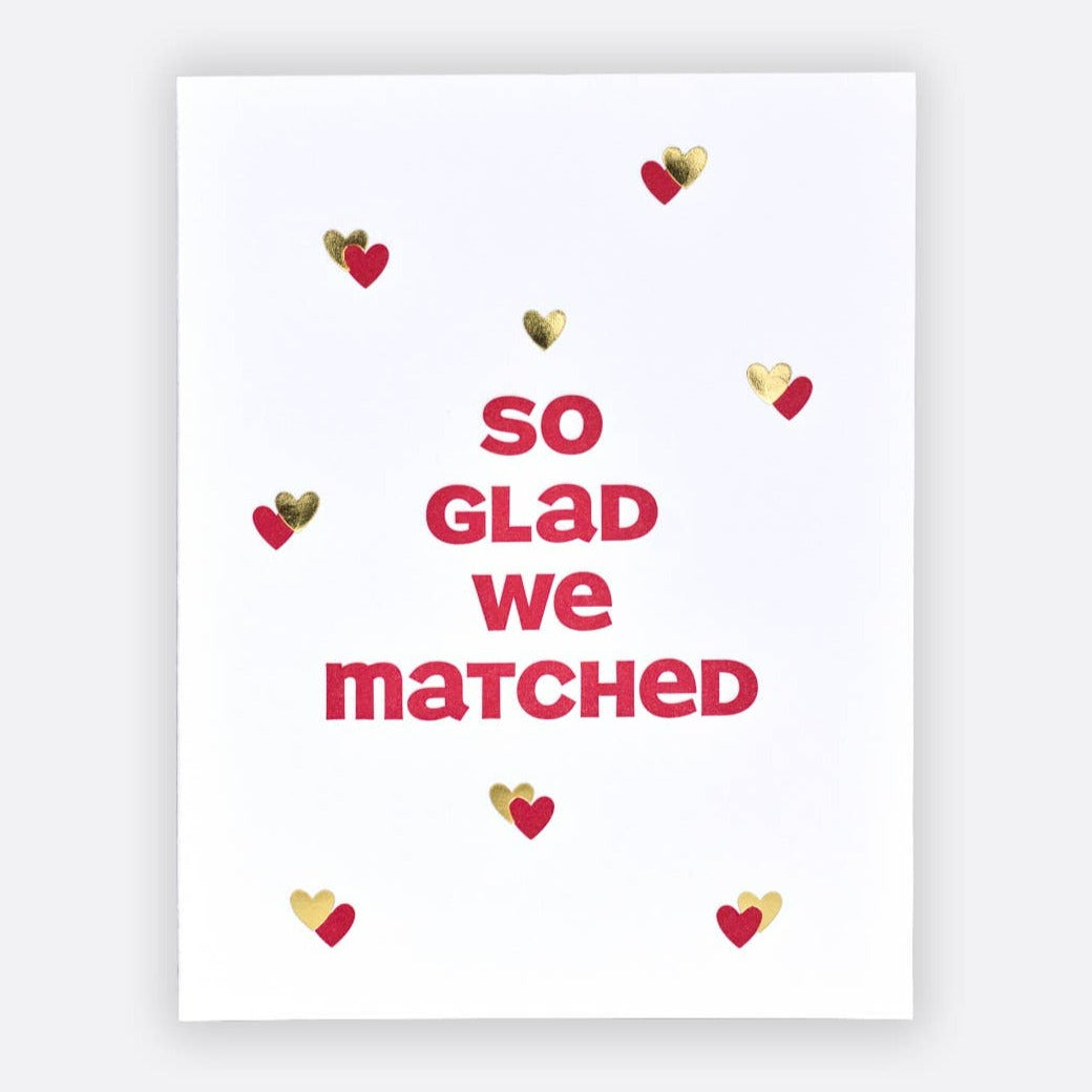 Elum Designs | We Matched Card | A white card with red and gold hearts and text that reads "so glad we matched".