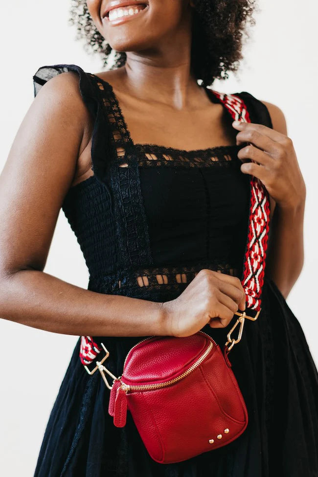 Ellie Crossbody Bag in red. This Faux-leather crossbody bag is so soft and dreamy. Comes with a trendy and fun canvas strap and shiny gold classic hardware! The size is small enough that you'll forget you're wearing it but big enough to fit your phone, keys, and wallet!