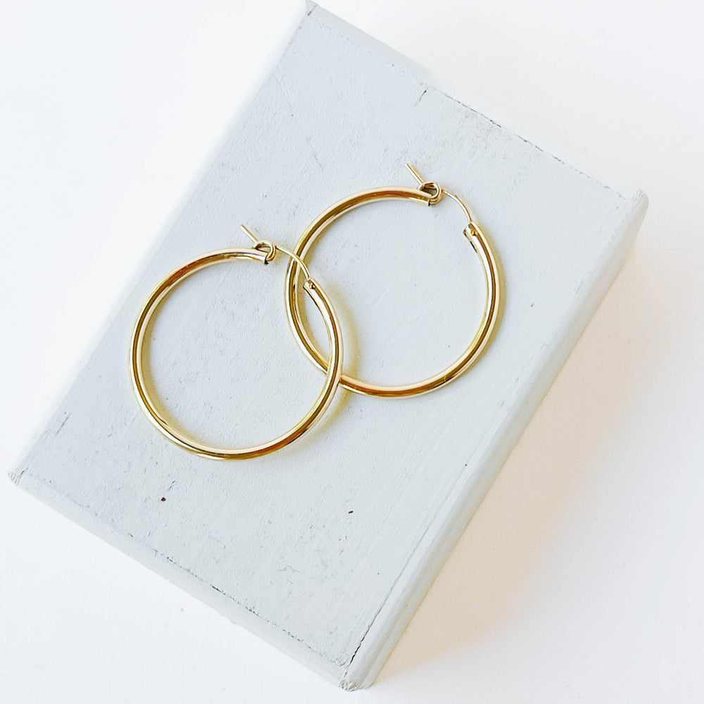 High-quality big 1.3" 14K Gold Filled hoop earings In hand.