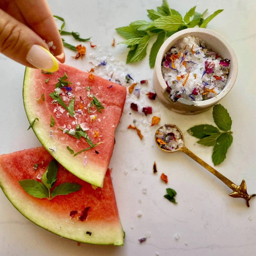 Flouwer Co | Garnishing Salt - Classic Floral | The garnishing salt being sprinkled over top of watermelon slices.