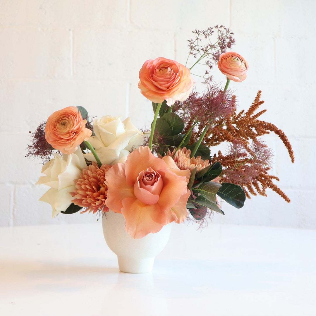 Orange Creamsicle | Stacy K Floral | Fresh Floral Arrangement | An orange and white focused arrangements with greens and browns accenting. Features reflexed roses, ranunculus.