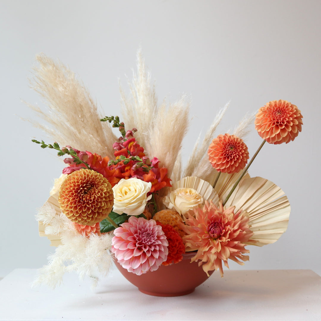boho style centerpiece in oranges and corals 