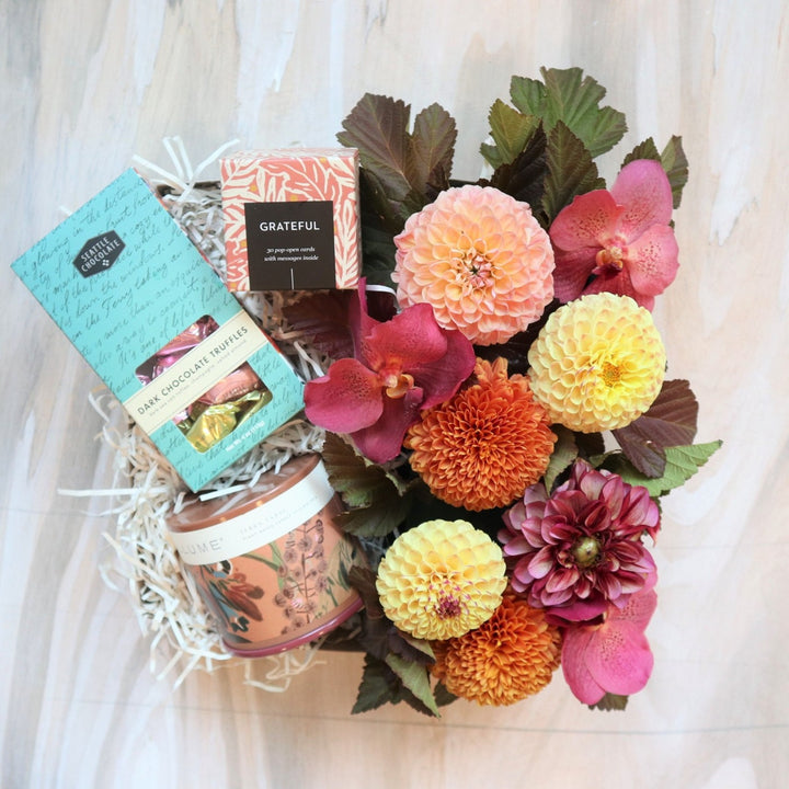 Grateful Gift Box | A colorful fall giftbox with chocolates, pop-open cards, a candle and a fresh floral arrangement highlighting dahlias and orchids.
