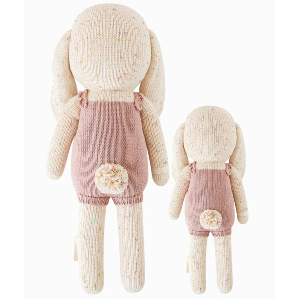 Harper the Bunny | Cuddle + Kind | Reverse image of the hand knit bunny plush showing the back of the romper and the fluffy tail.
