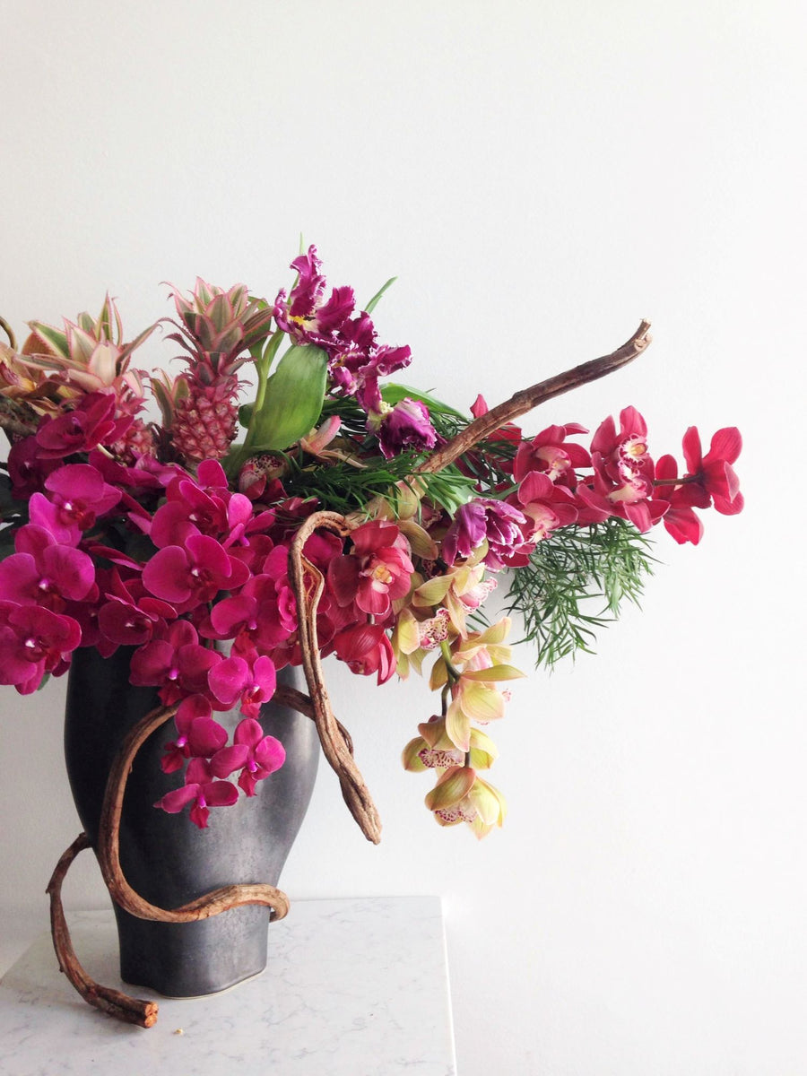 large dramatic floral arrangement with orchids and branching