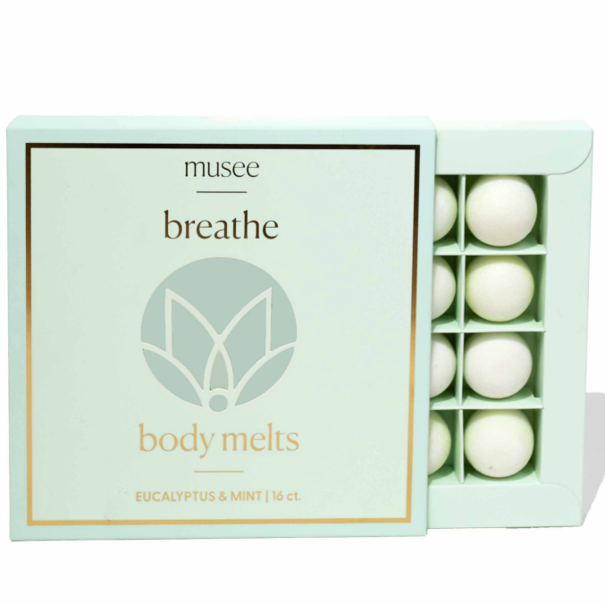 Musee 'breathe' body melts packaging with white melts inside on a light green background