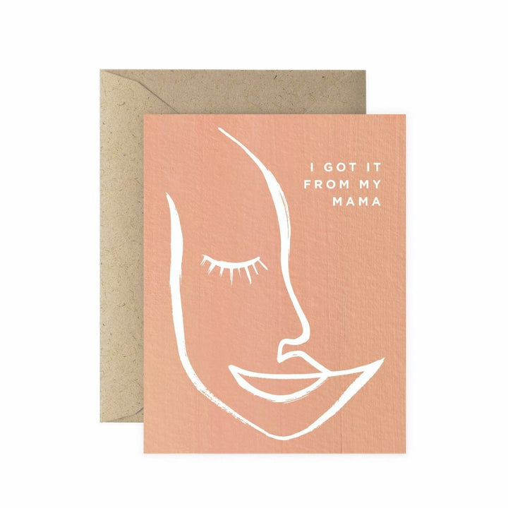 Paper Anchor Co.| From My Mama Greeting Card | A light pink card with a simplistic face drawing at text that reads "I got it from my mama".