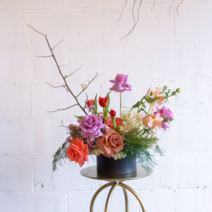 rose, tulip, hydrangea arrangement with branch